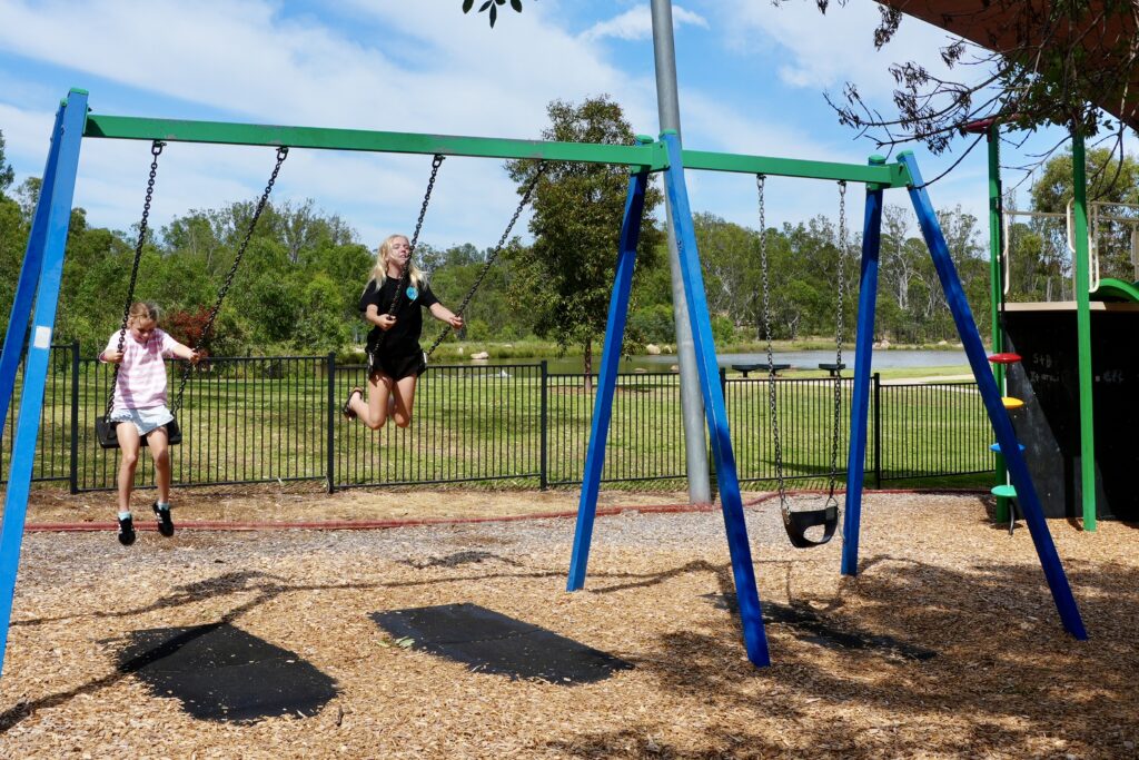 kids swinging on a swing set