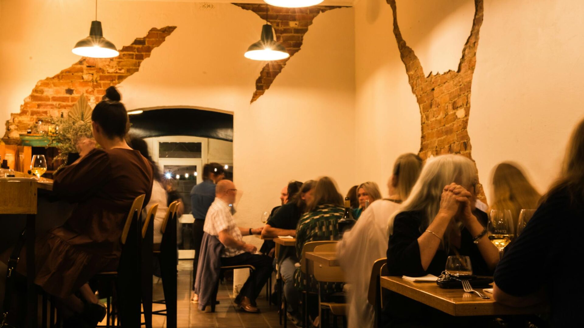 People sitting down dining in low low lit room