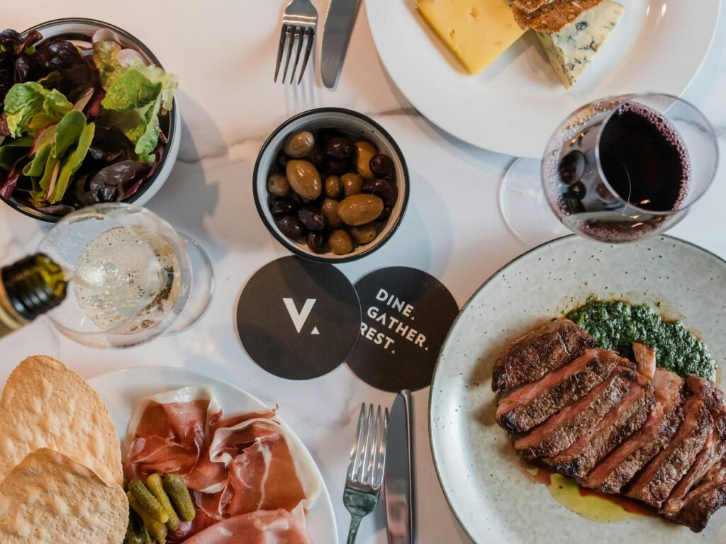 A dining table with plenty of food and drink