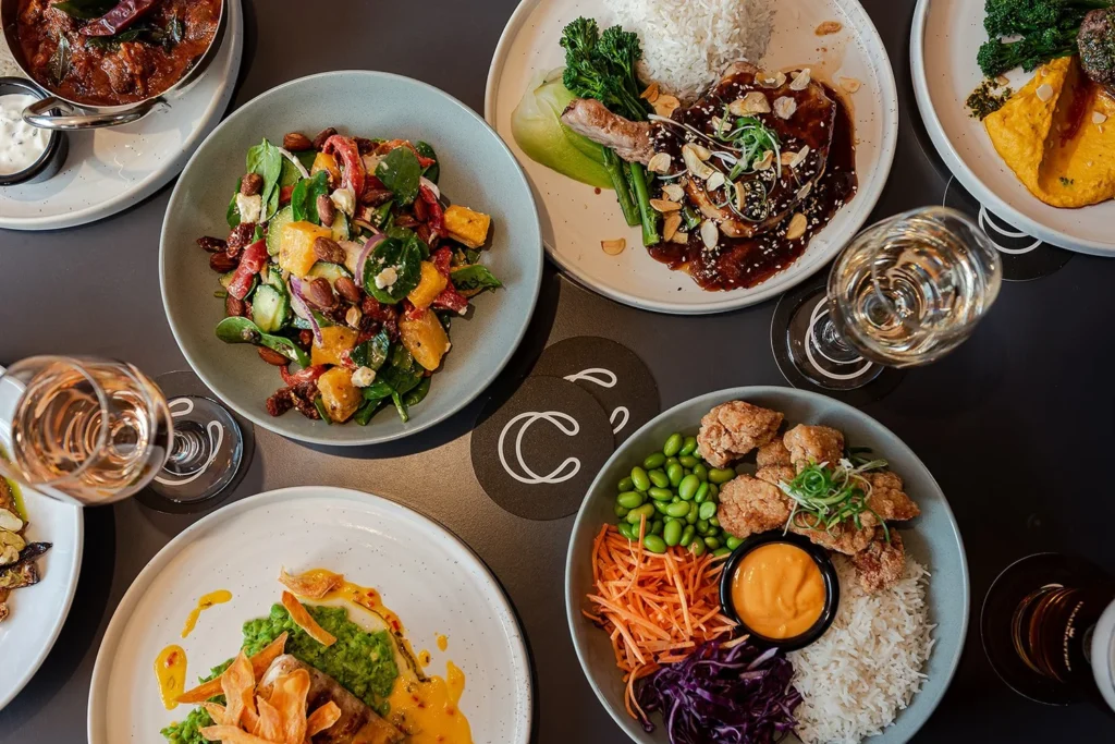 a ohoto of a lot of bistro meals on a dining table