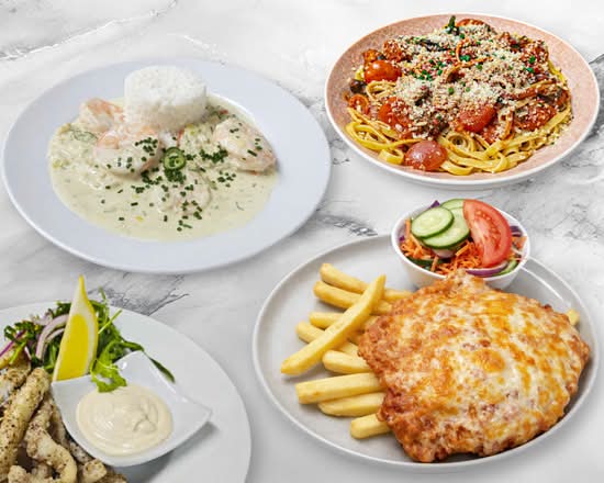 Pub meals on plates including garlic prawns and a parmi