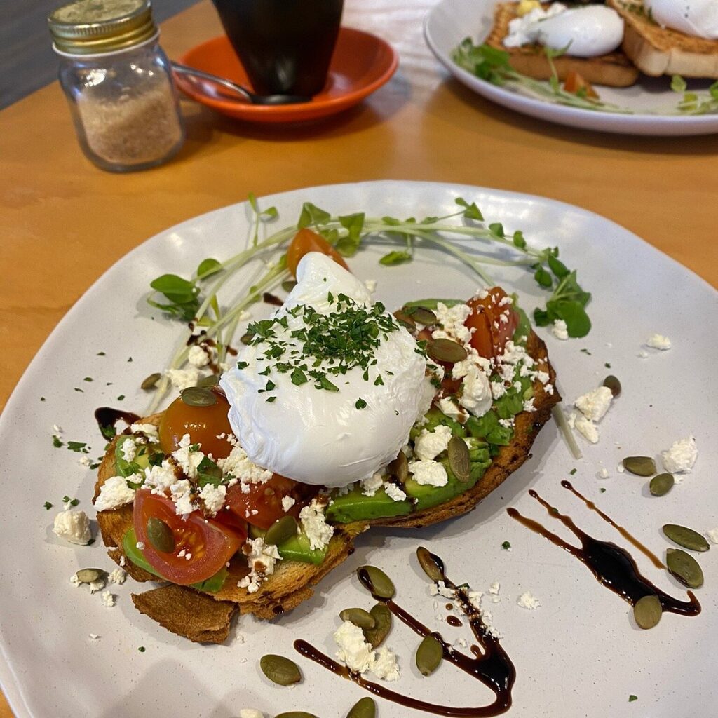 A photo of an egg and smashed avocado breakfast